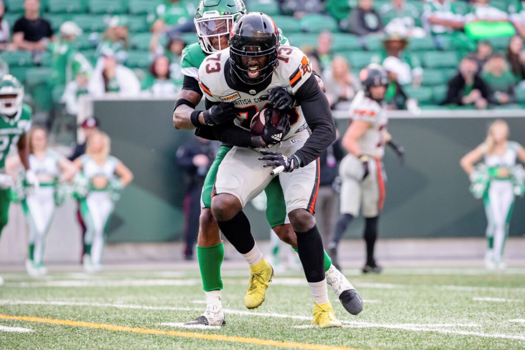 Photo of two football players at a Saskatchewan Roughriders game.