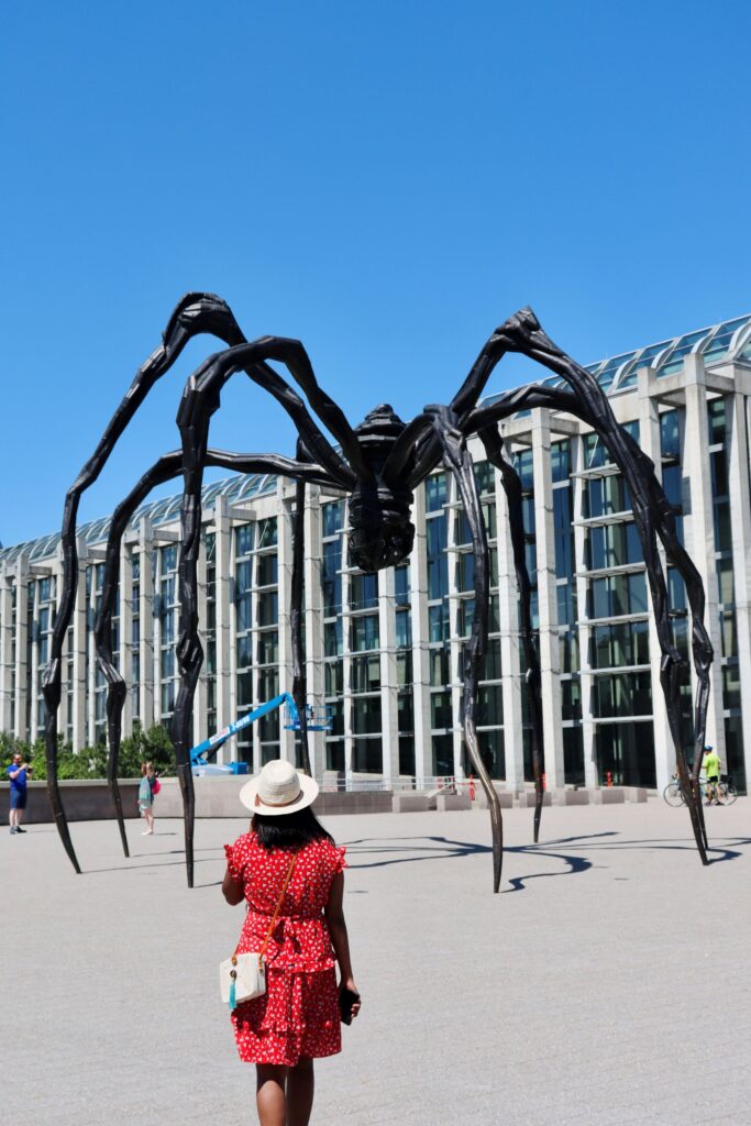 Photo of woman standing in front of the Maman Sculpture at the National Gallery of Canada. Ottawa what to do between ottawa and montreal why you should visit  best places to explore why is ottawa the best place to live