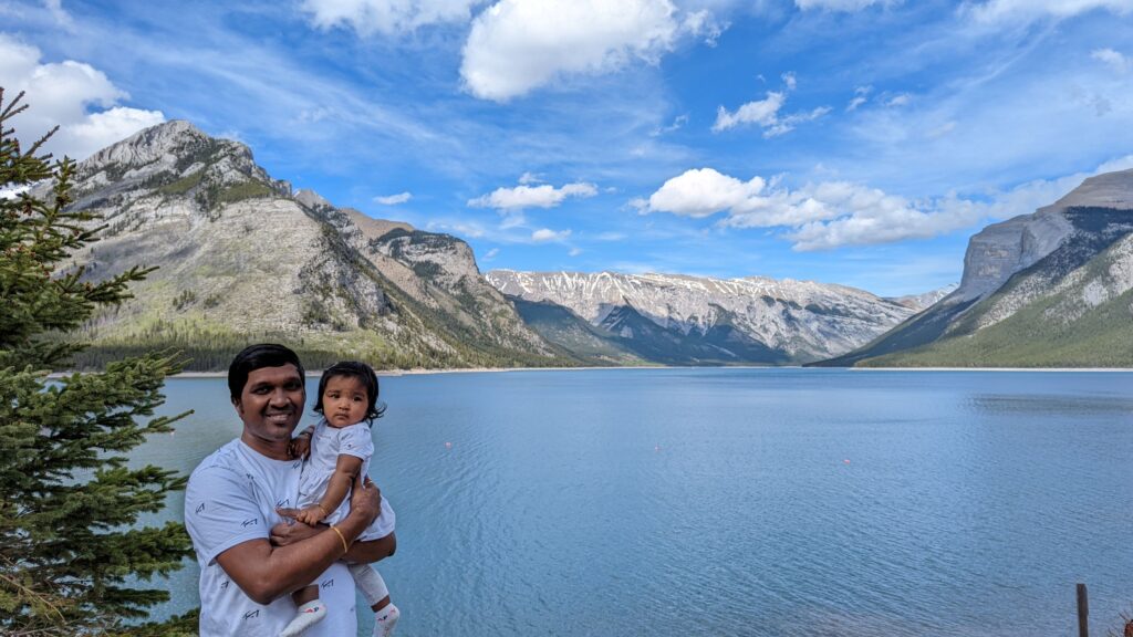 Image of a family in front of a blue lake with mountains in the background. A Weekend in Banff Plan a weekend trip to Banff What to do in Banff