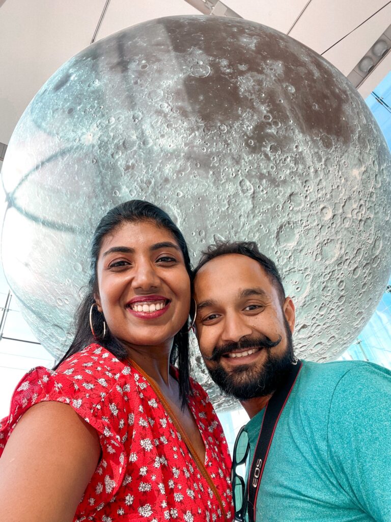 Photo of a couple in front of a moon sculpture at the Museum of Nature. Ottawa what to do between ottawa and montreal why you should visit  best places to explore why is ottawa the best place to live