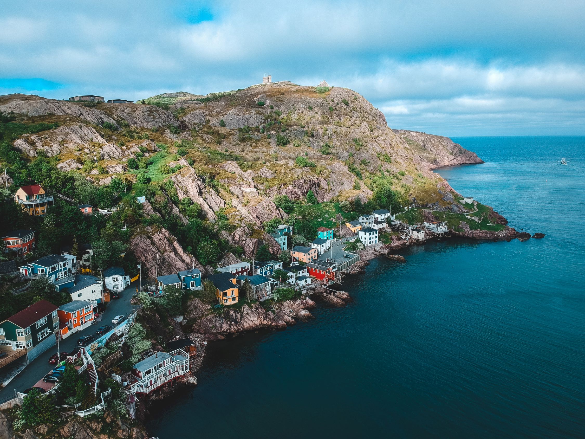 Image of colourful houses along the coastline in Newfoundland and Labrador.