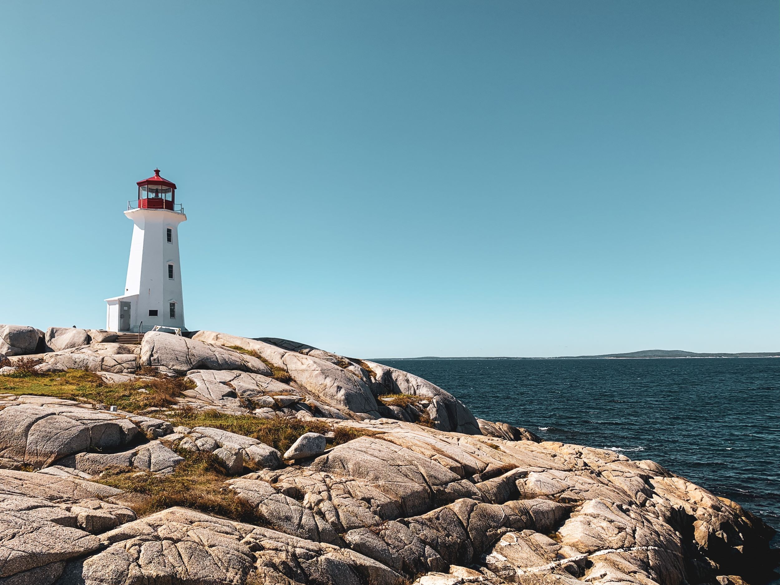 Photo of red and white lighthouse in Peggy's Cove, Nova Scotia.