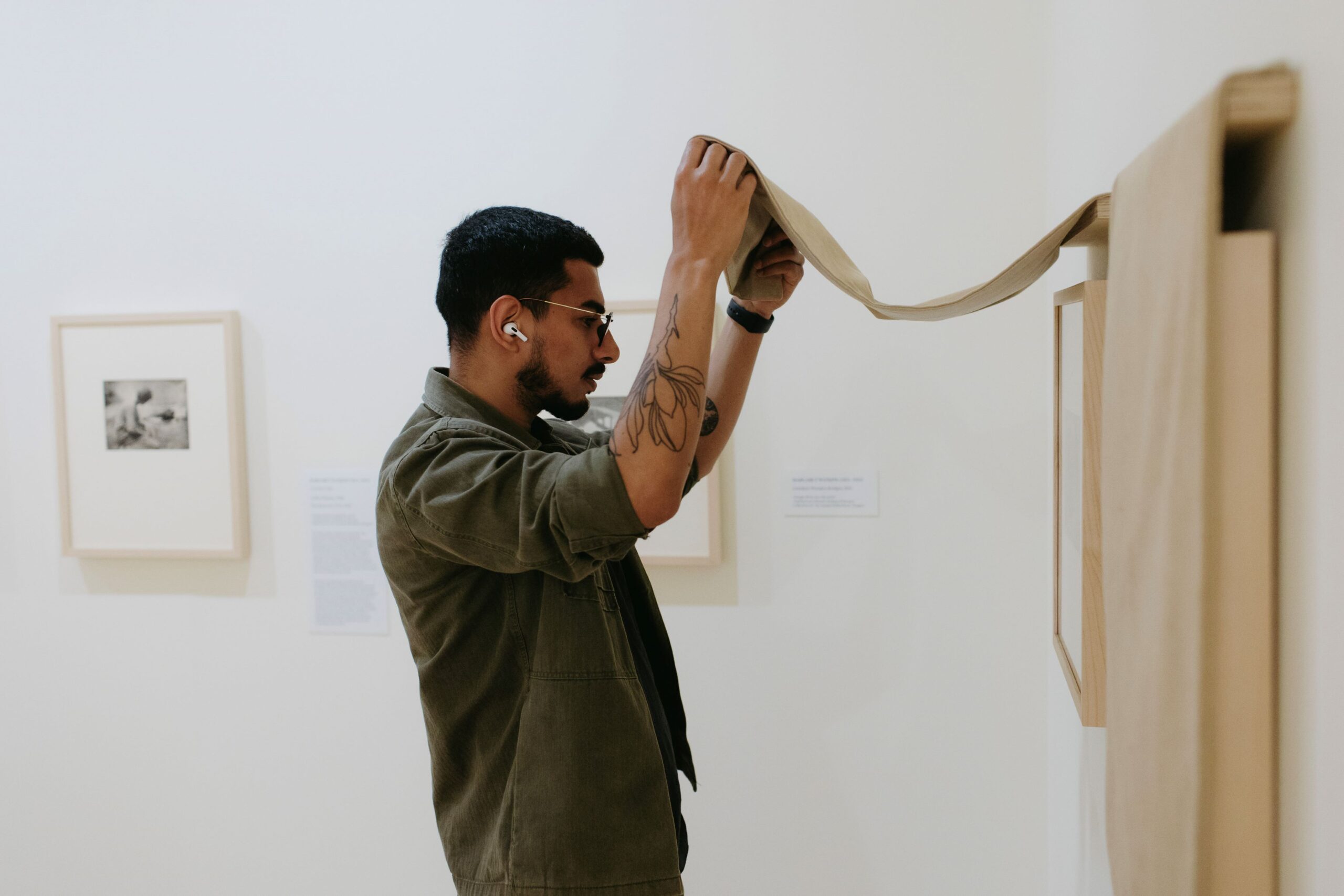 Photo of person in an art gallery looking at a portrait on a white wall using their Canoo membership for free entrance.