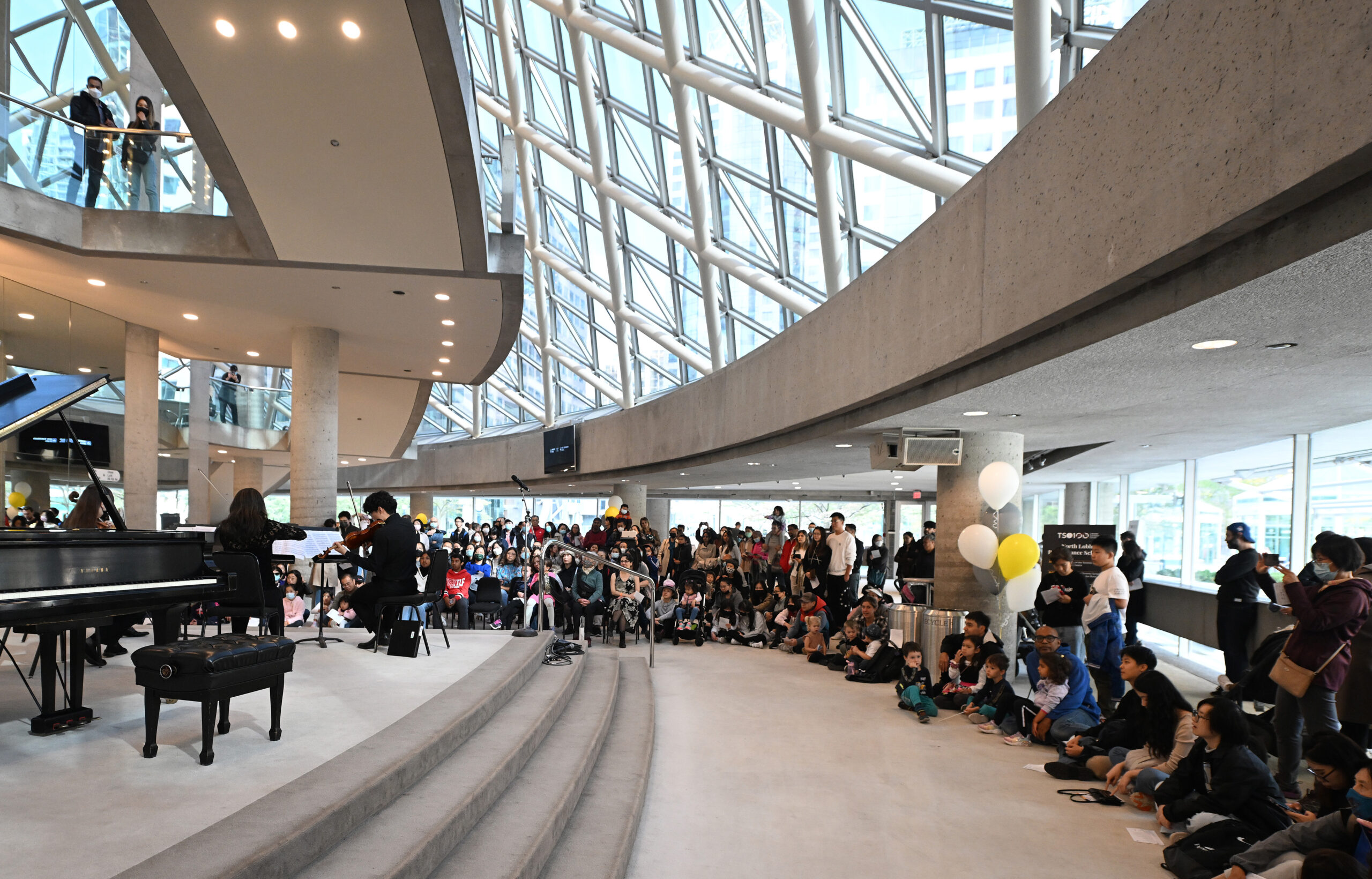 Members of the Toronto Symphony Orchestra in front of a crowd.