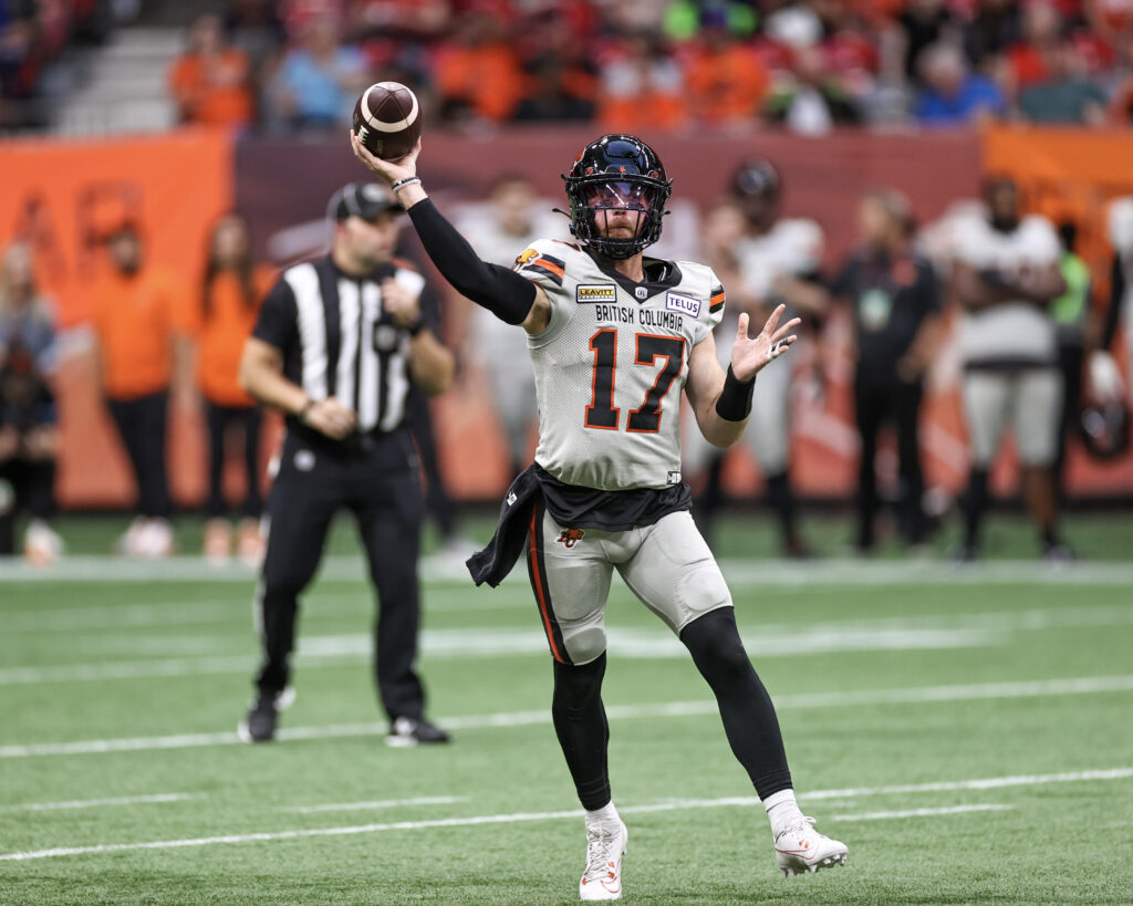 BC Lions player throwing football in CFL Grey Cup game.