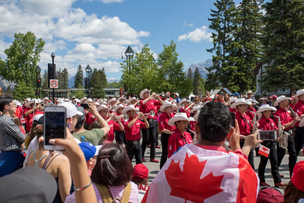 People watching a Canada Day parade.