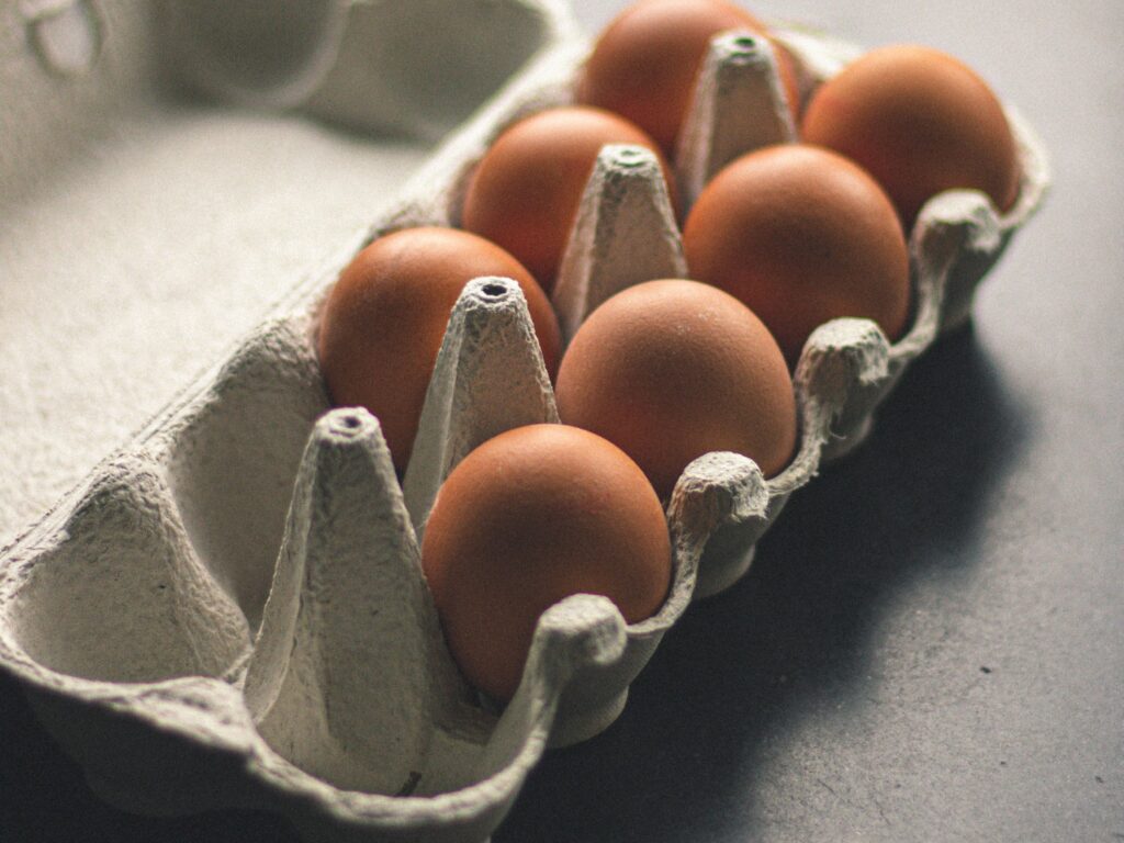 An egg carton with seven eggs.