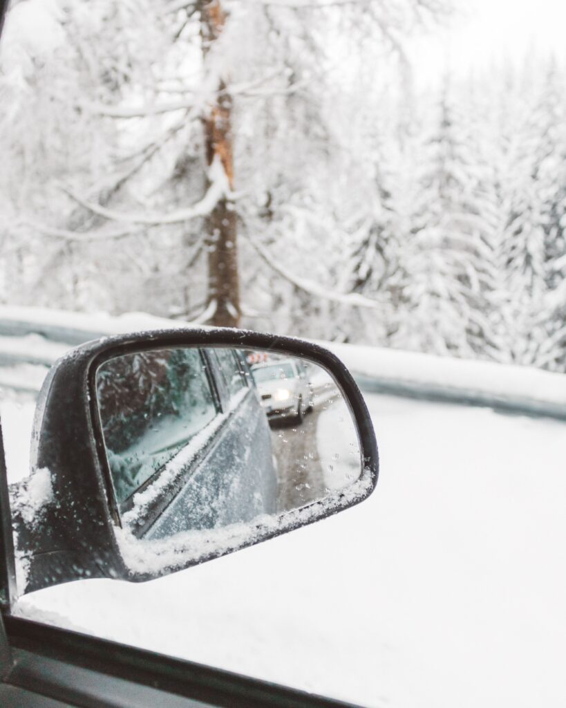 The side mirror of a car during winter in Canada.