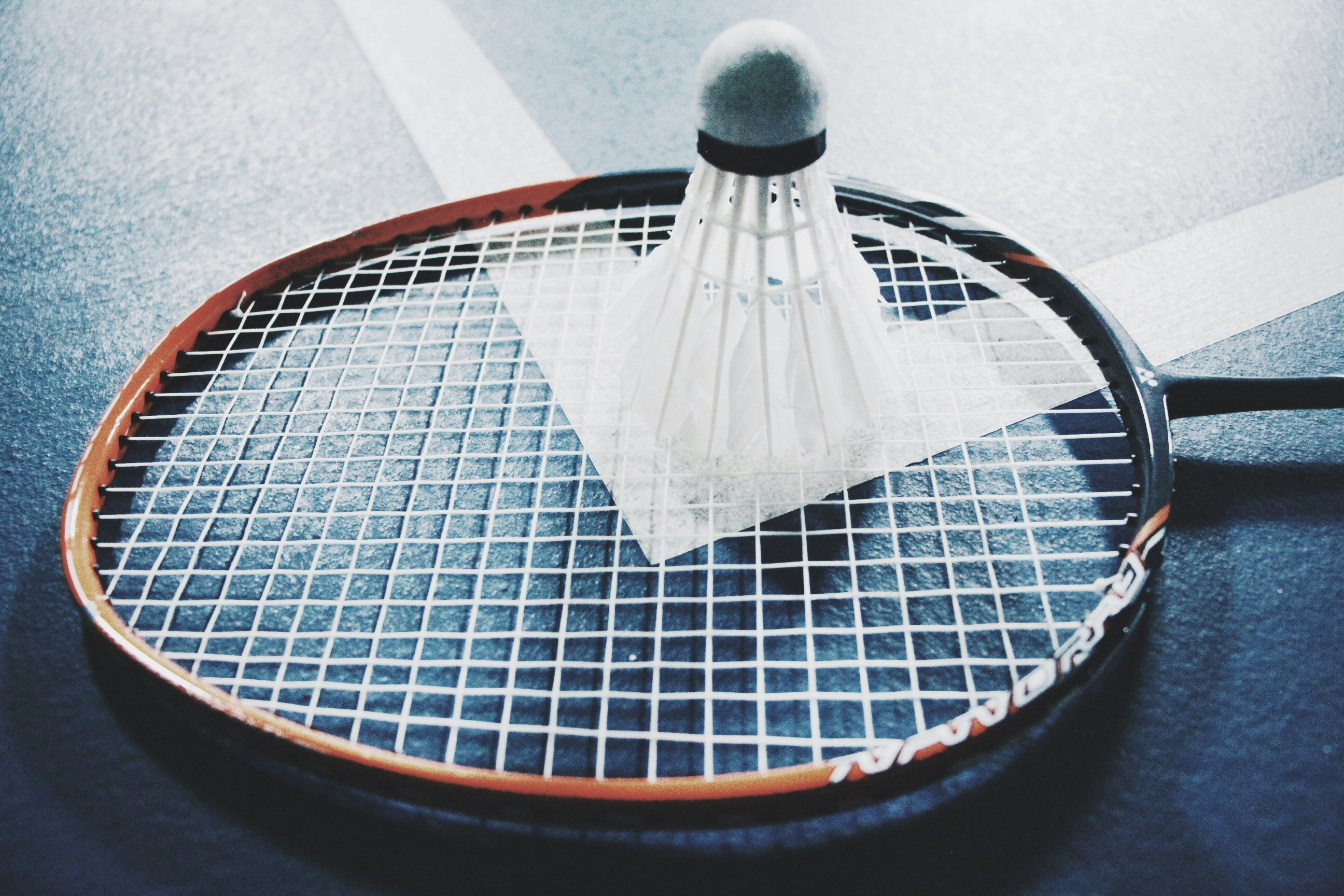 Badminton equipment lying on a court.