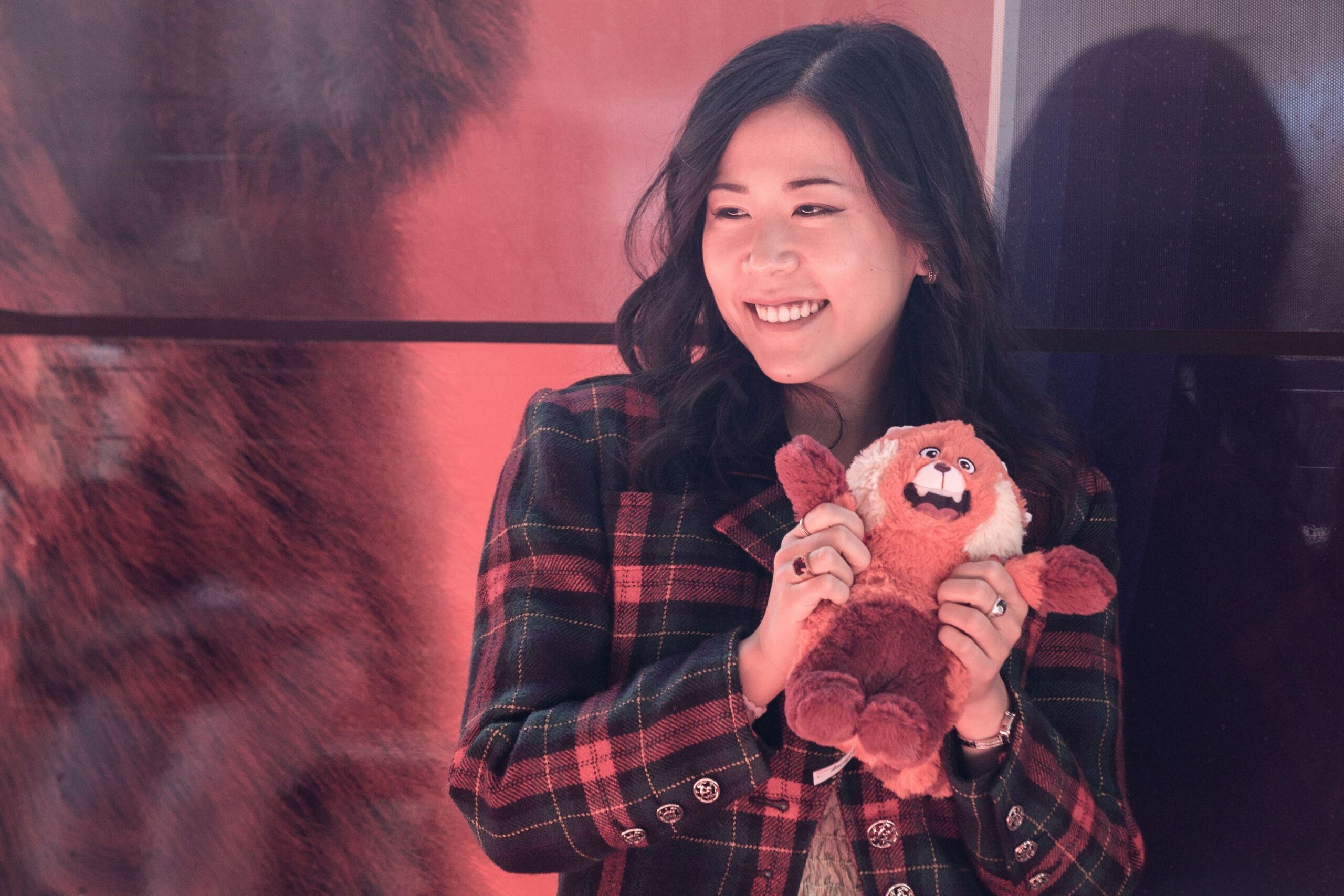 Photo of Domee Shi holding a stuffed animal.