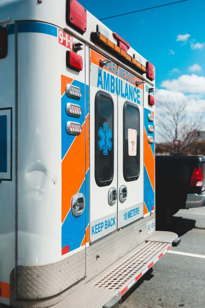 A photo of the back of an ambulance with closed doors in an emergency.