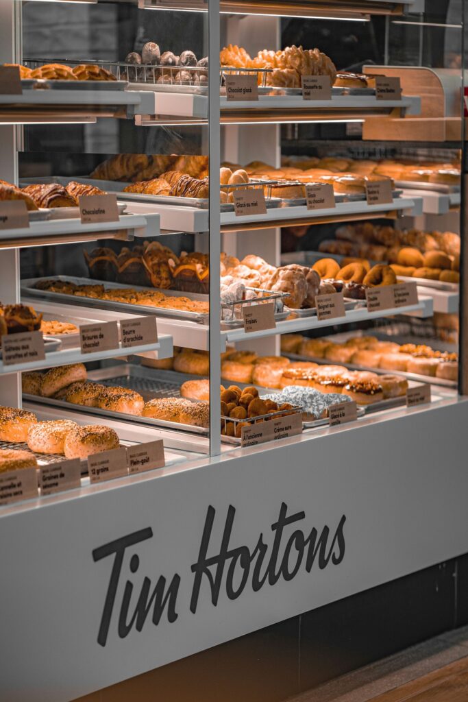Photo of donuts on display in a Tim Horton's Restaurant.