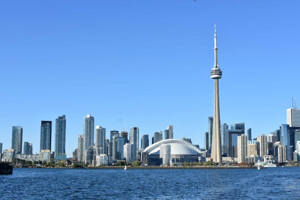 Toronto city scape behind a large body of water during the day