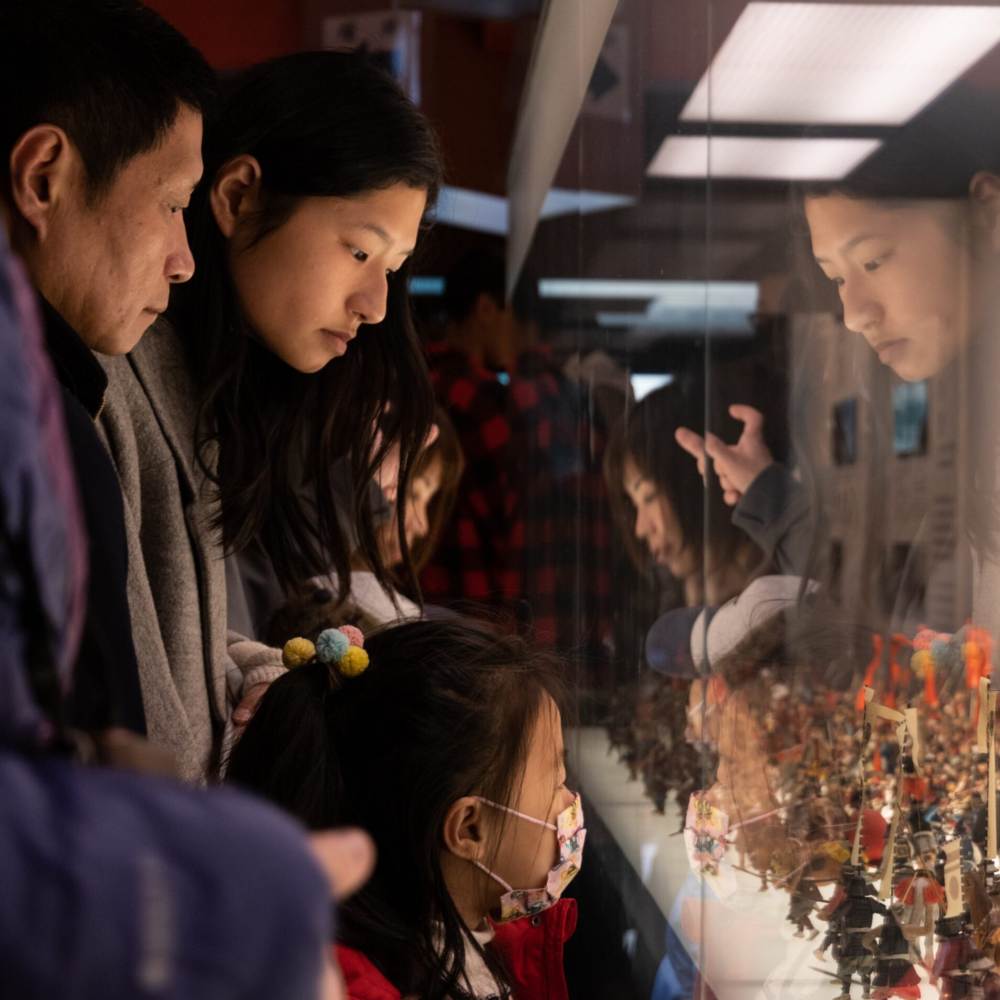 Family looking at a museum exhibit in Vancouver.