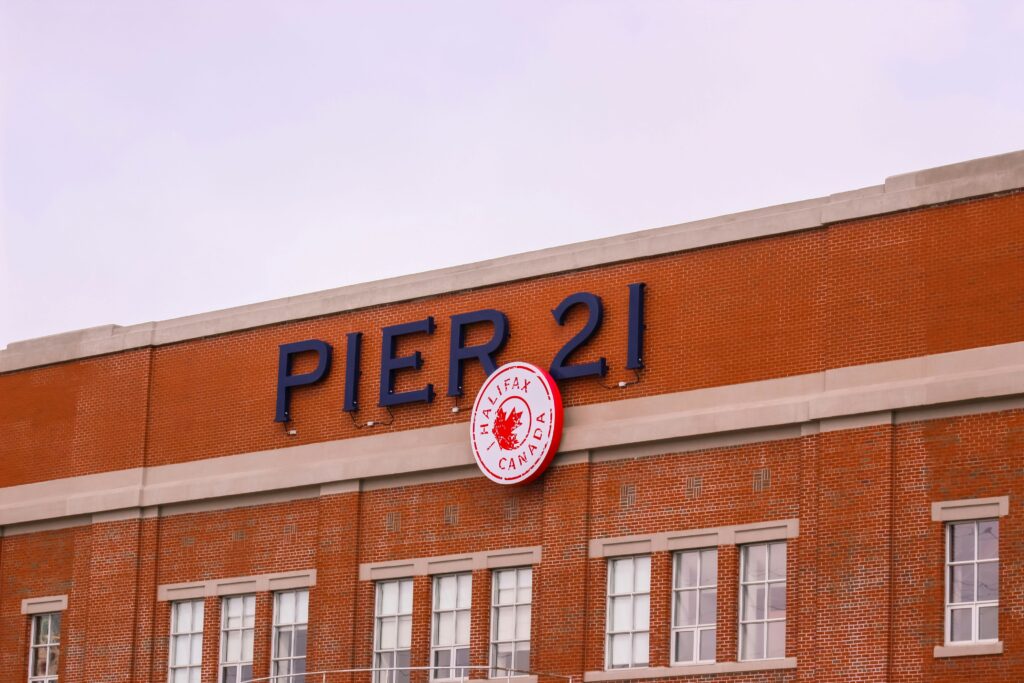 Photo of a red brick building with the sign that says Pier 21 in Halifax.