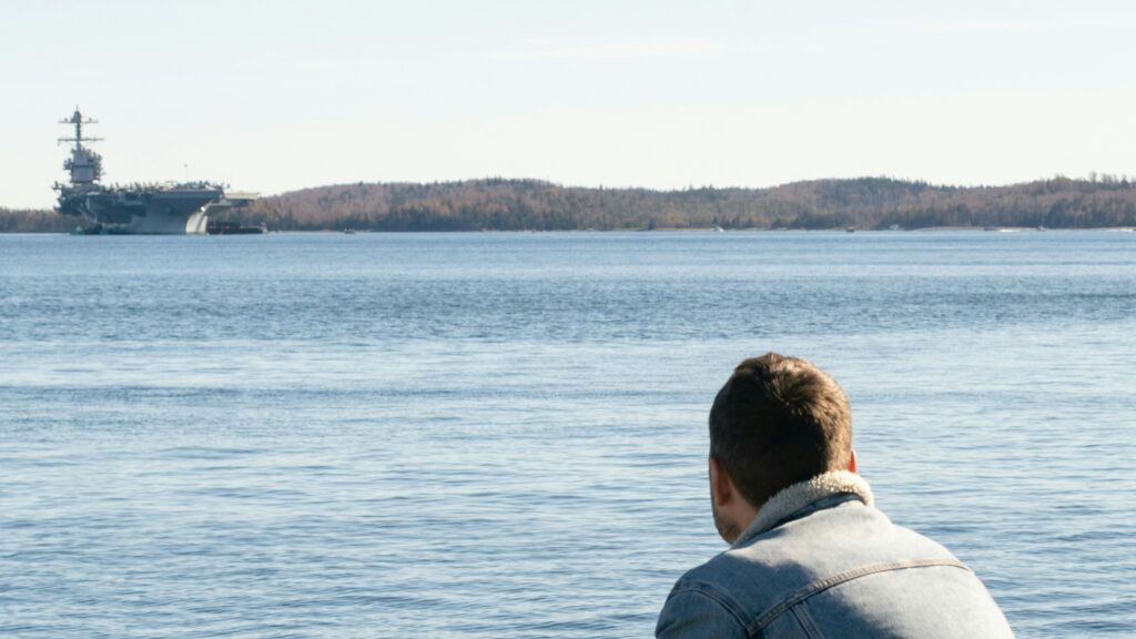 An image of a person looking out at the Halifax waterfront.