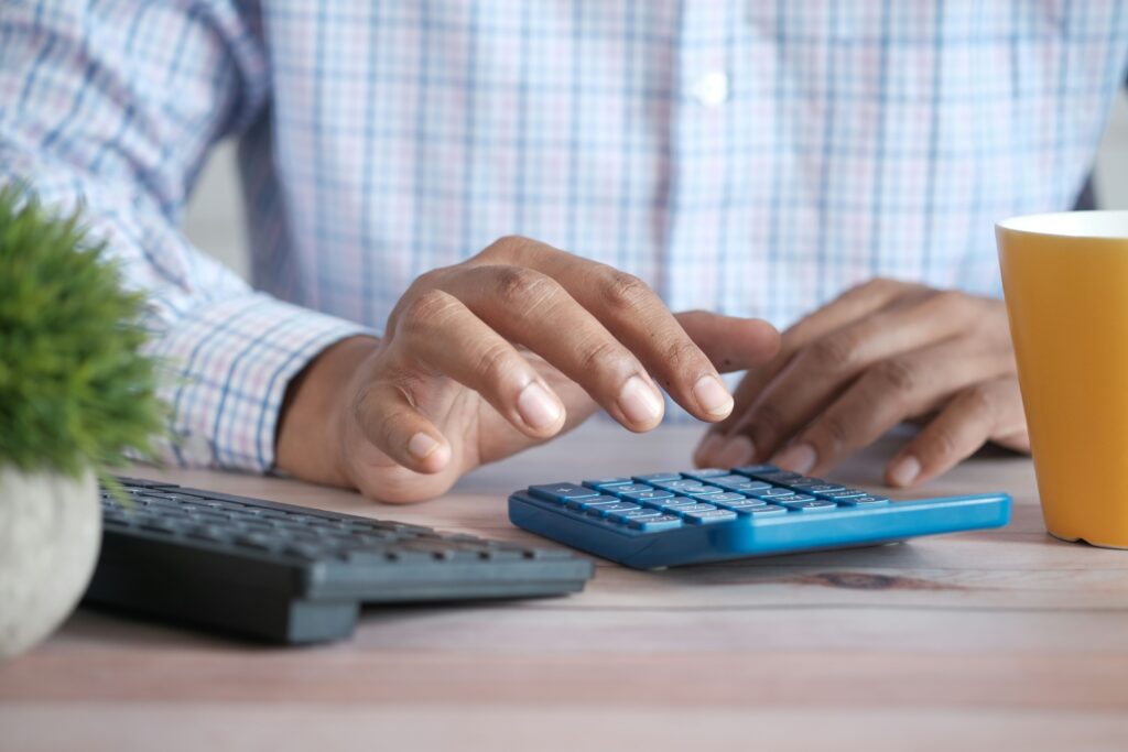 Person using a calculator for their taxes.
