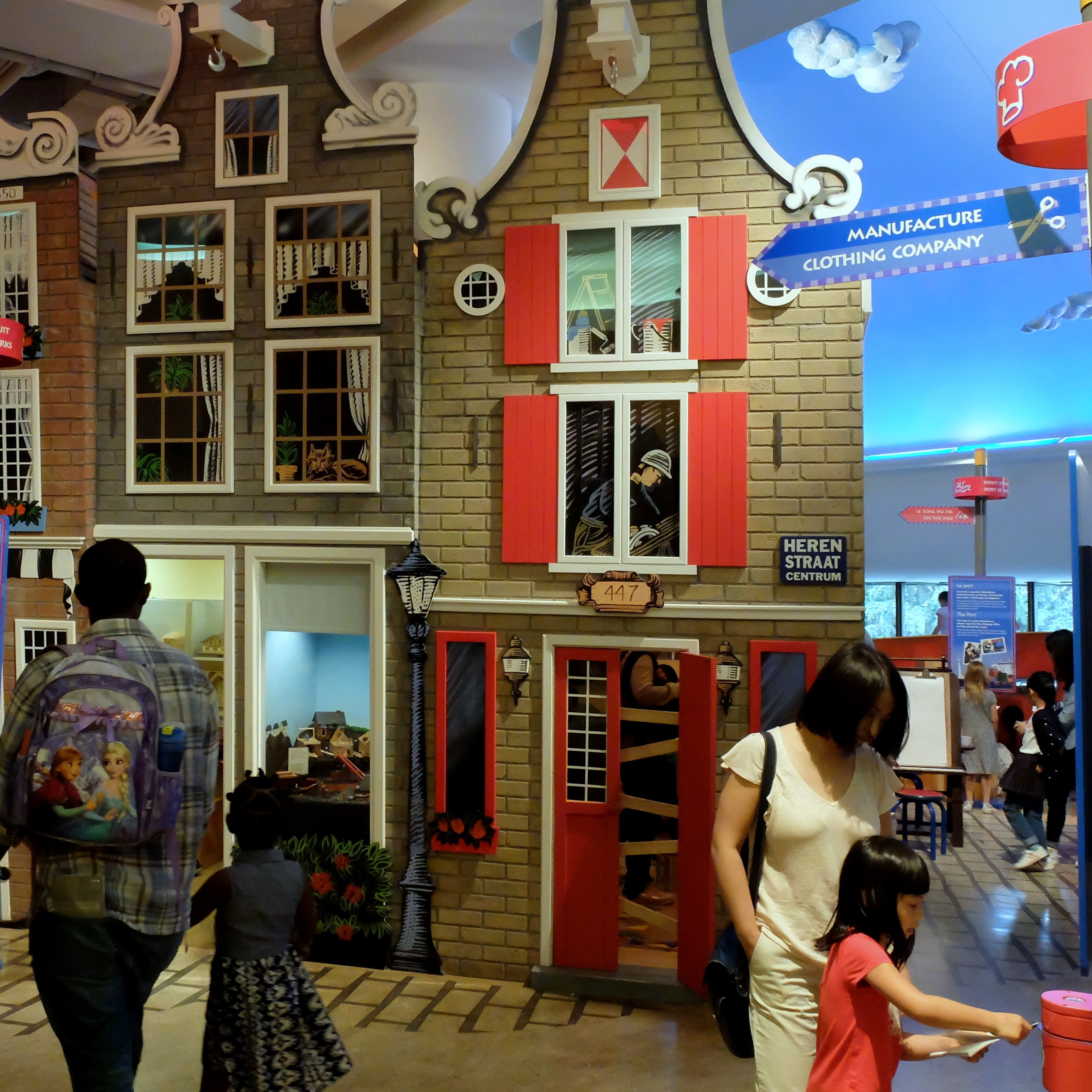 Families wandering through a tiny town in the Canadian Children's Museum.