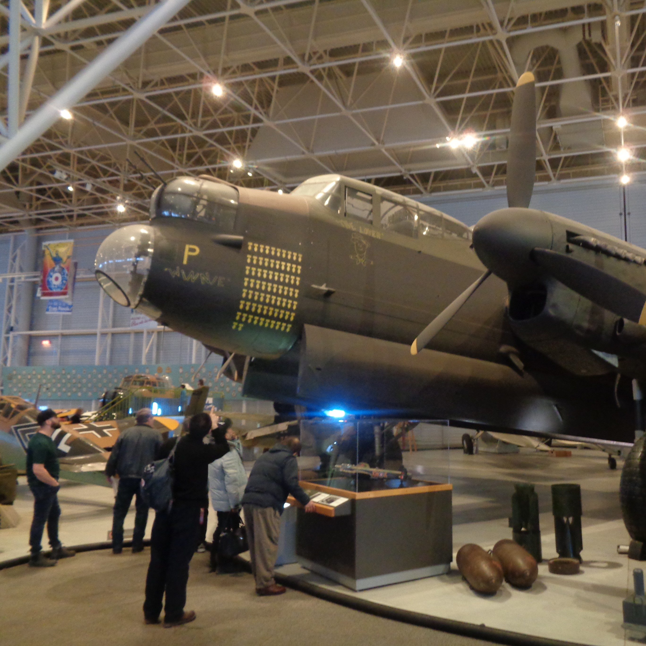 Families looking at a Lancaster Bomber at the Canada Aviation and Space Museum.