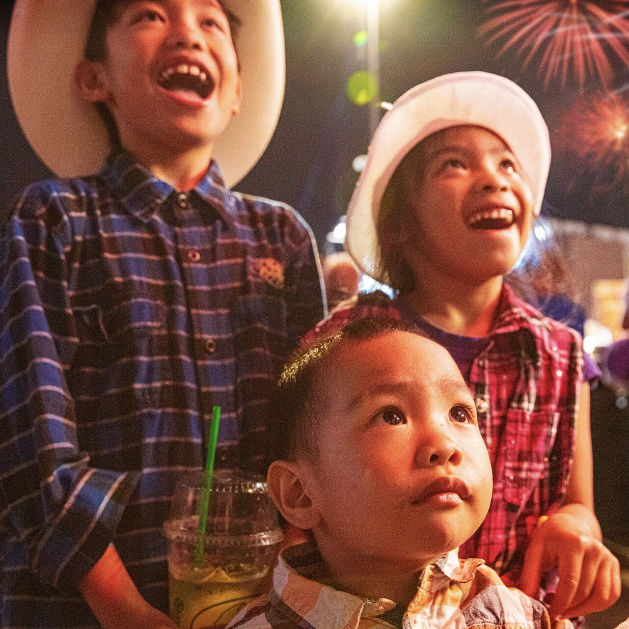 Happy children watching fireworks at the Calgary Stampede.