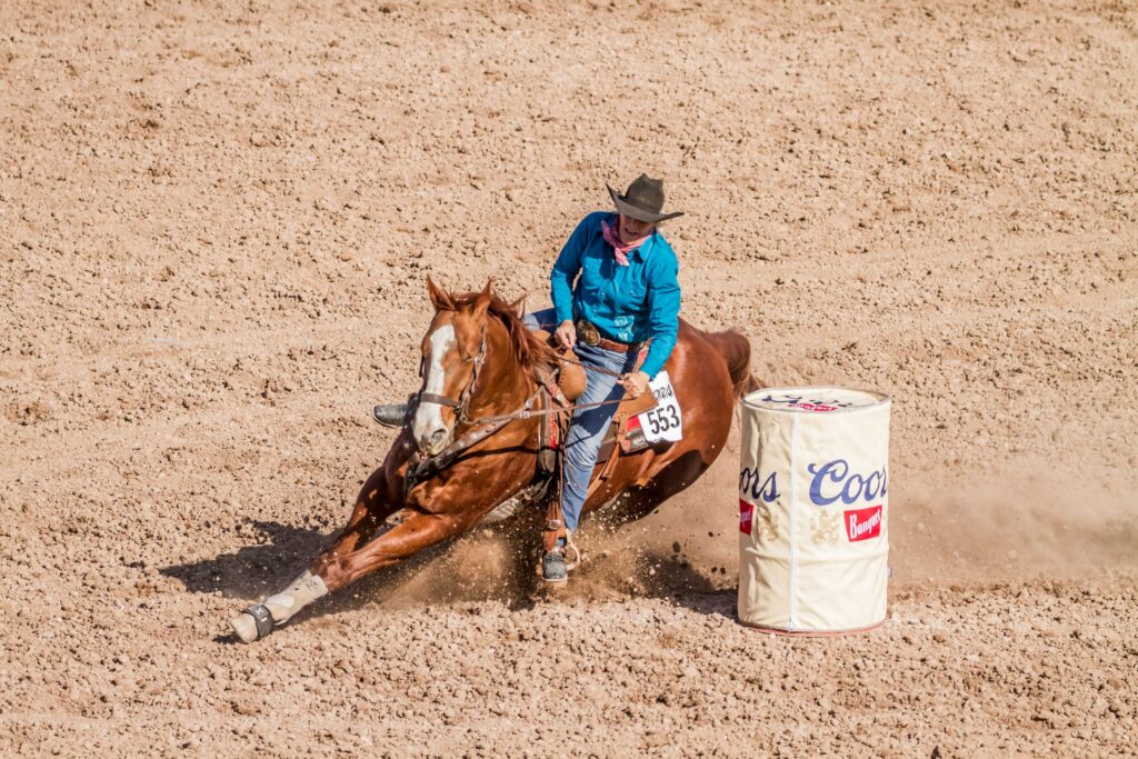A person competing in barrel racing at the Calgary Stampede.