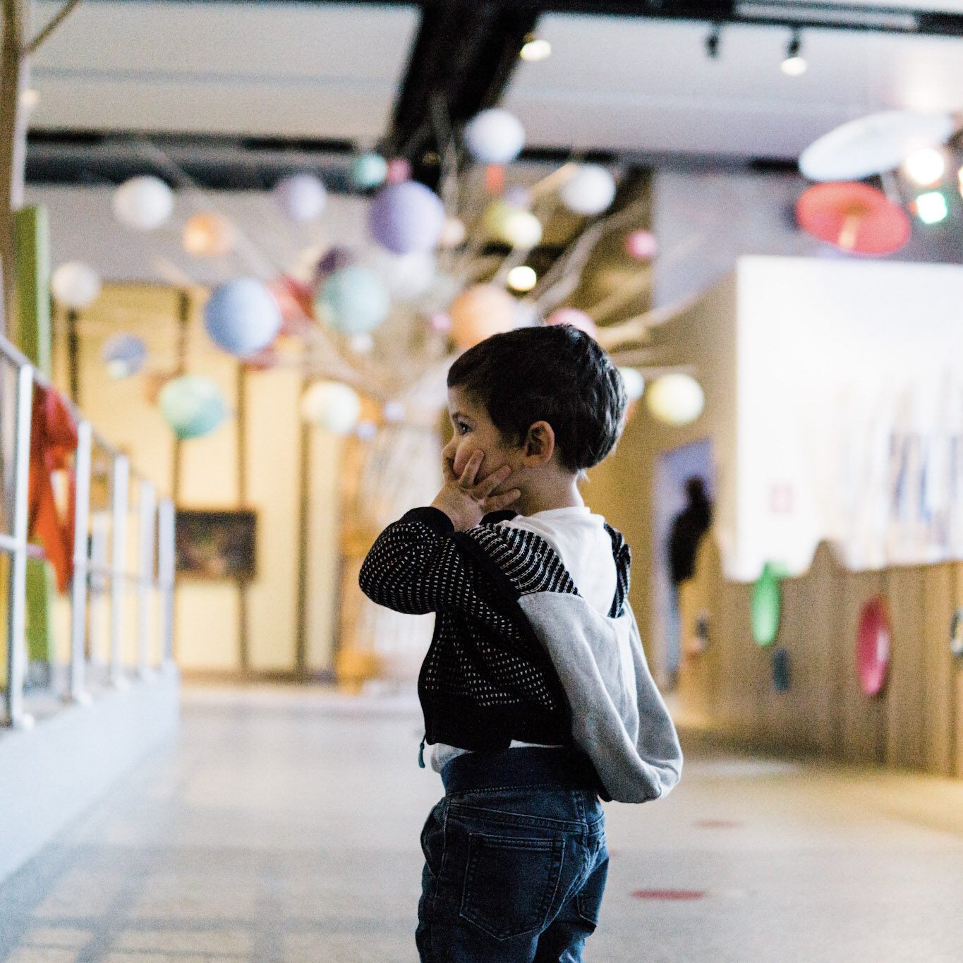 Toddler looking around at the TELUS Spark Science Centre.