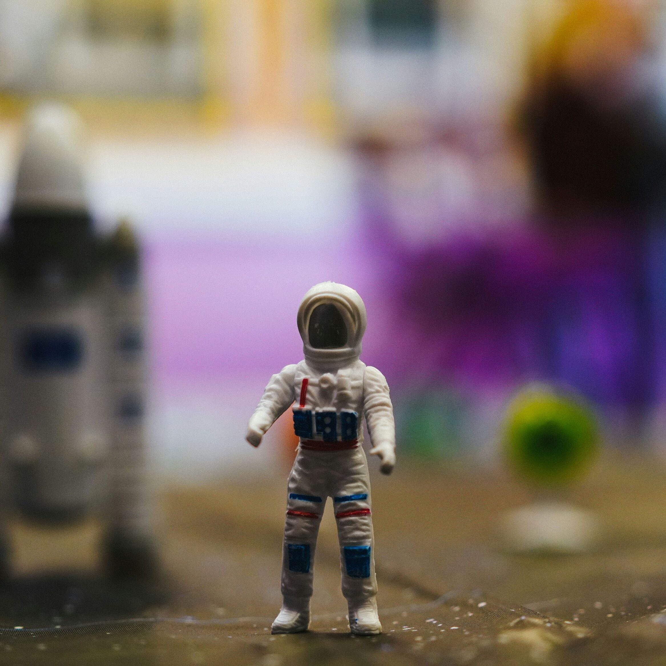 Miniature astronaut doll with a space shuttle in the background at the Planetarium.