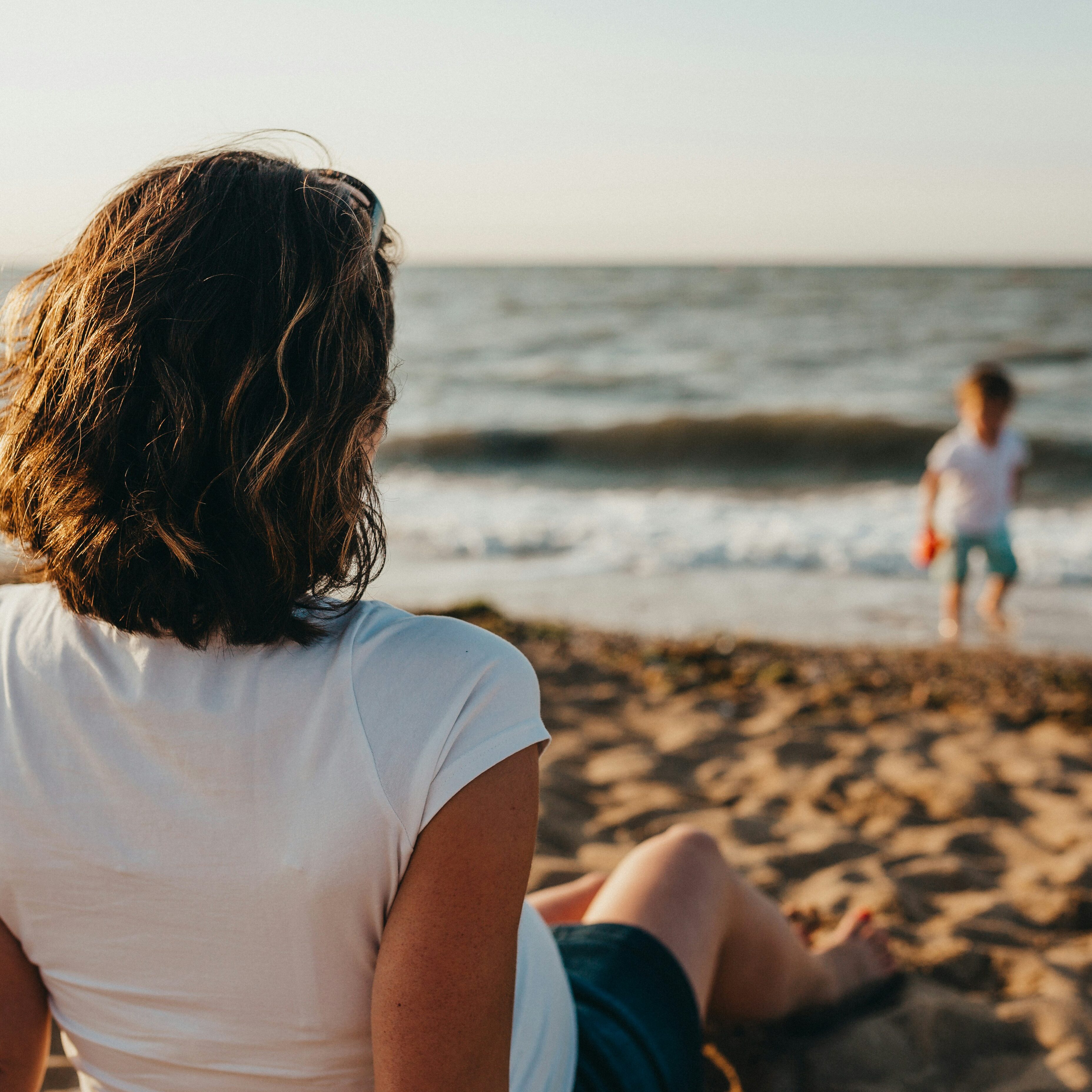Parent with child at a beach.
