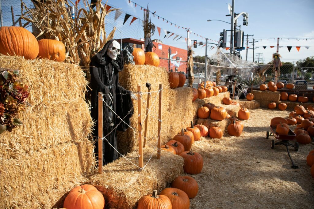 A maze decorated with the grim reaper and pumpkins on hay for halloween