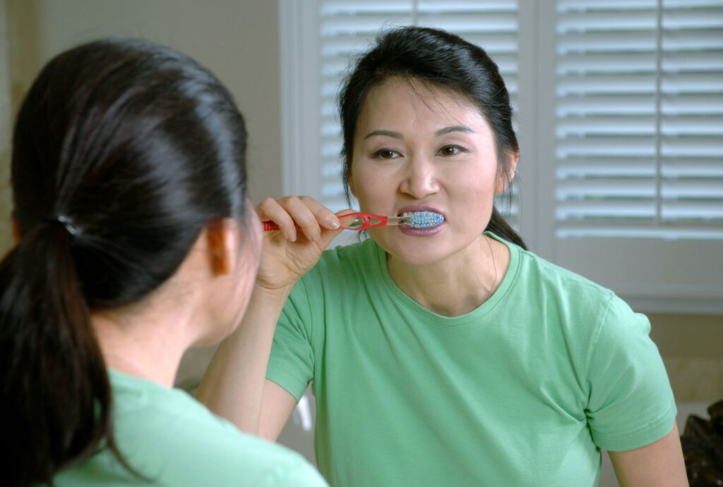 A person brushing their teeth.