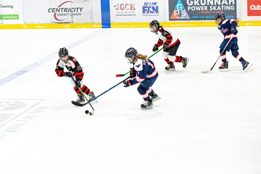 a group of young women playing a game of ice hockey