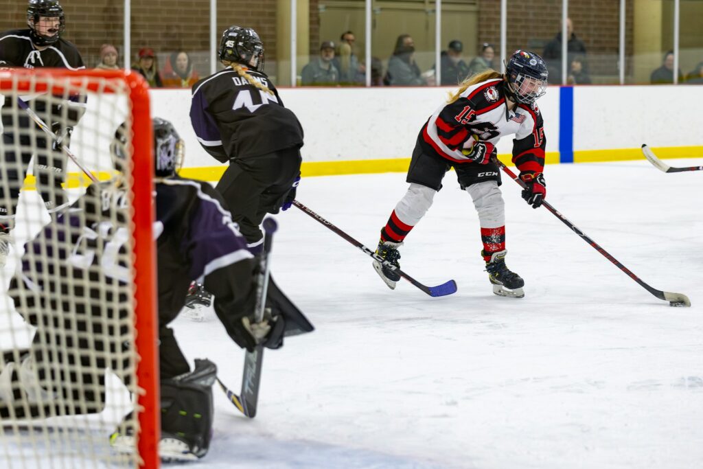 a group of women playing a game of ice hockey 