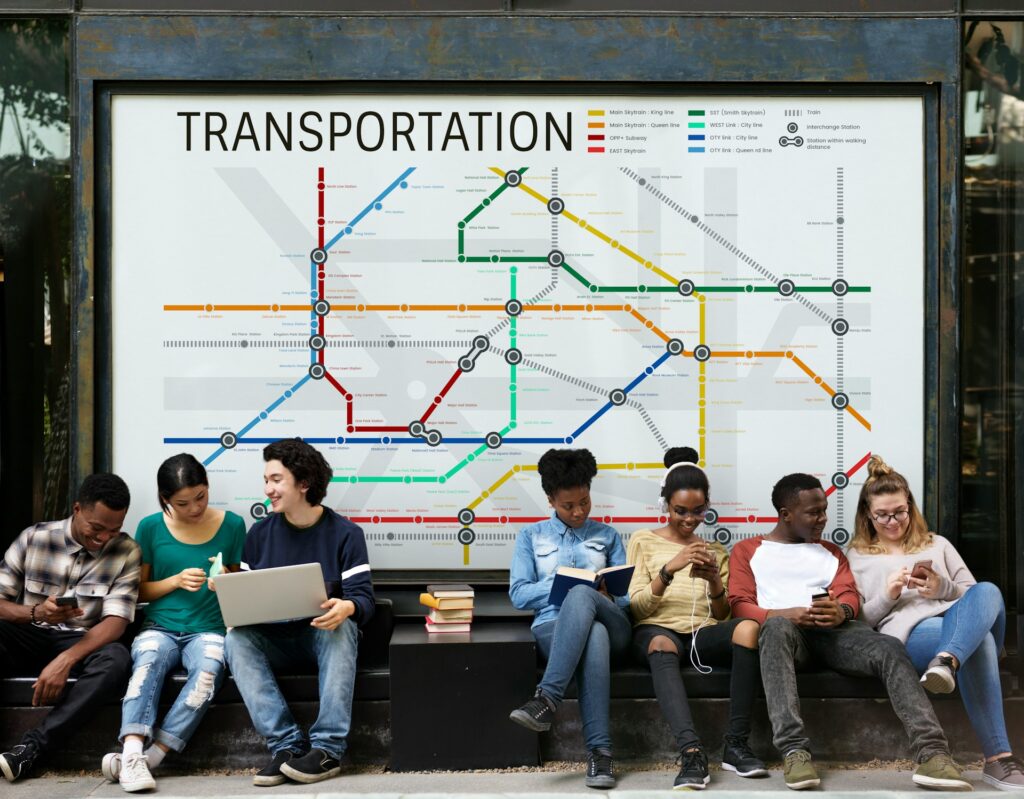 People sitting on a bench with a transit map in the background 