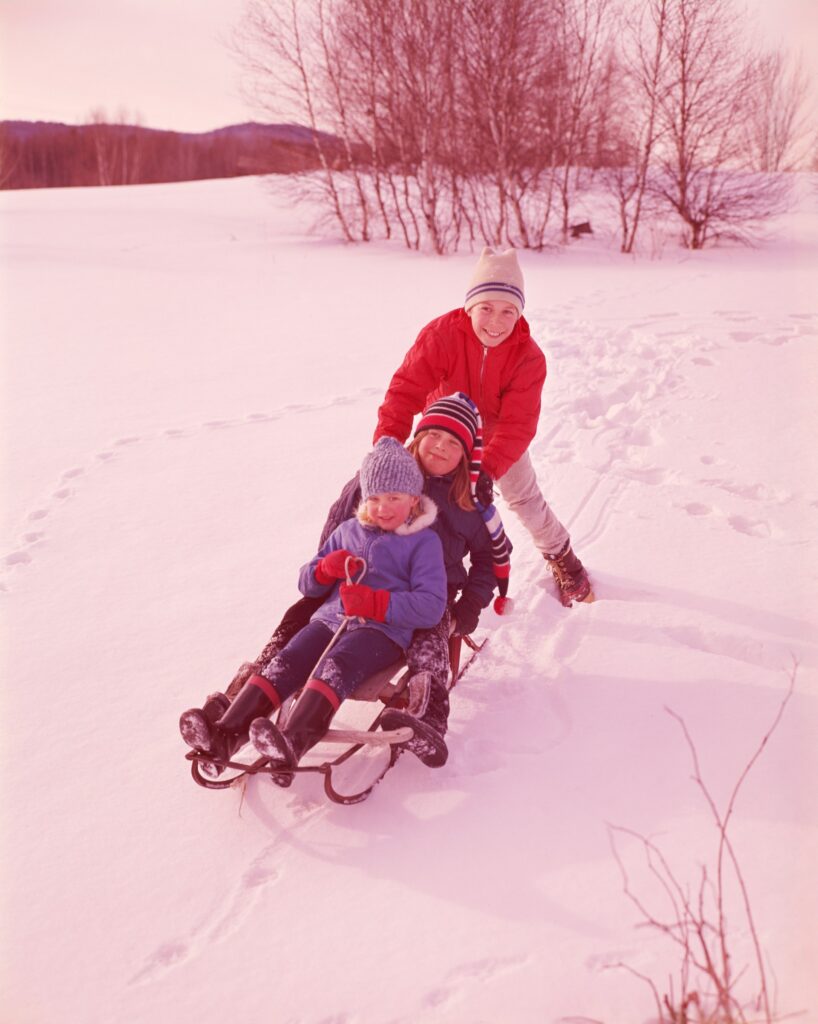 Children on a toboggan also known as a sled