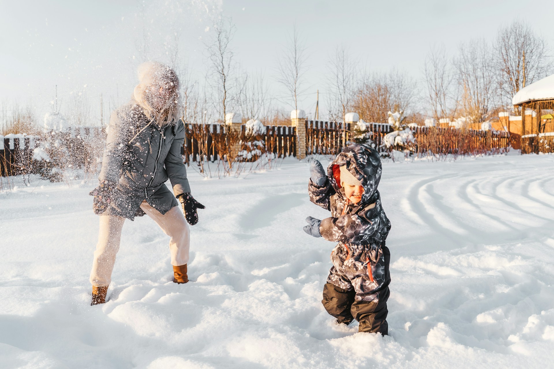 Happy Mother and child playing in the snow