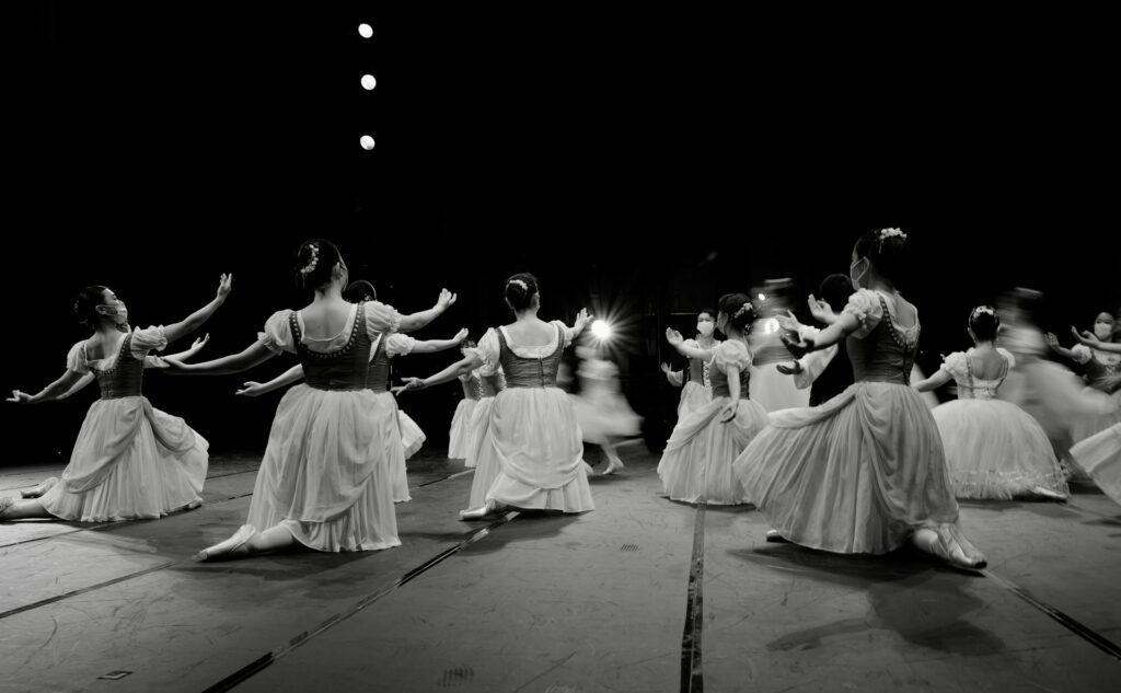 A group of women performing ballet on a stage 