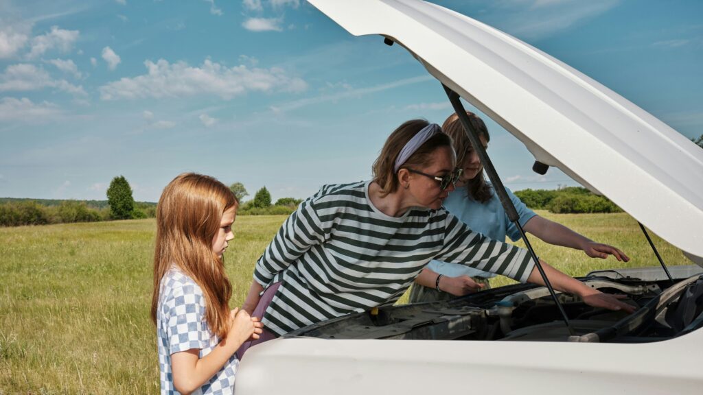 Family checking their car that has broken down.