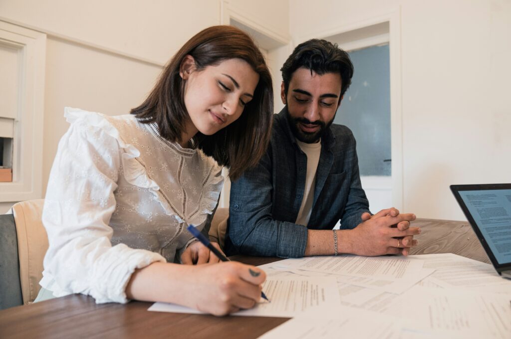 People signing a document after a home inspection.