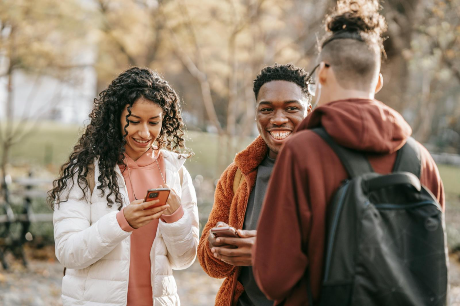 A group of friends using their phones.