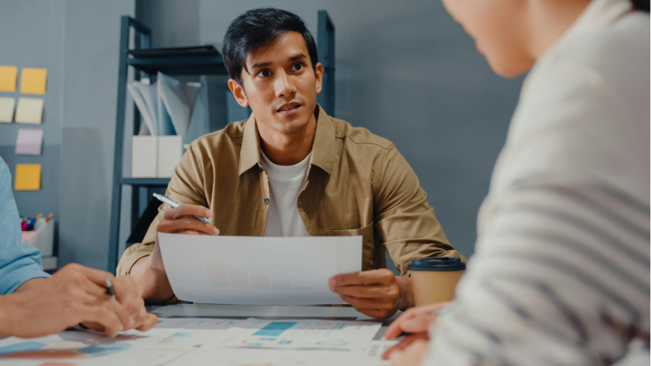 A young person meeting with their financial advisor.